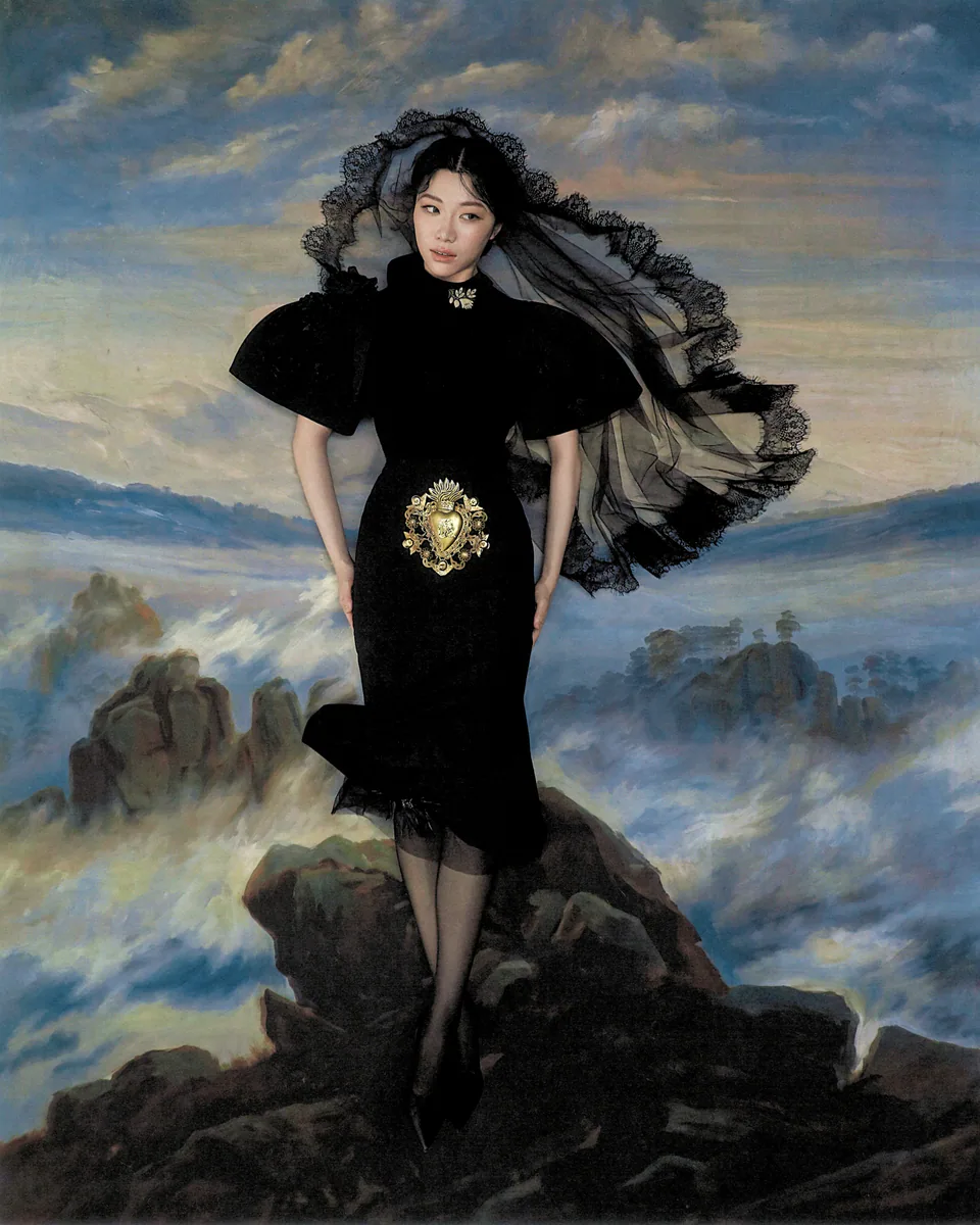 Sammi Chen in a black dress standing above a painted cloudscape.