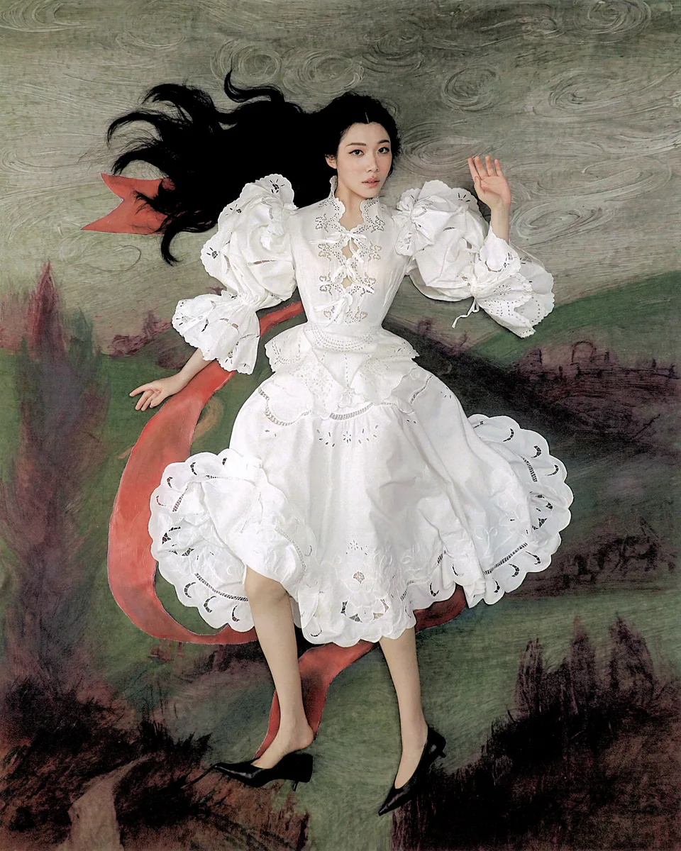 Sammi Chen in a white ruffled dress reclining in a painted landscape.